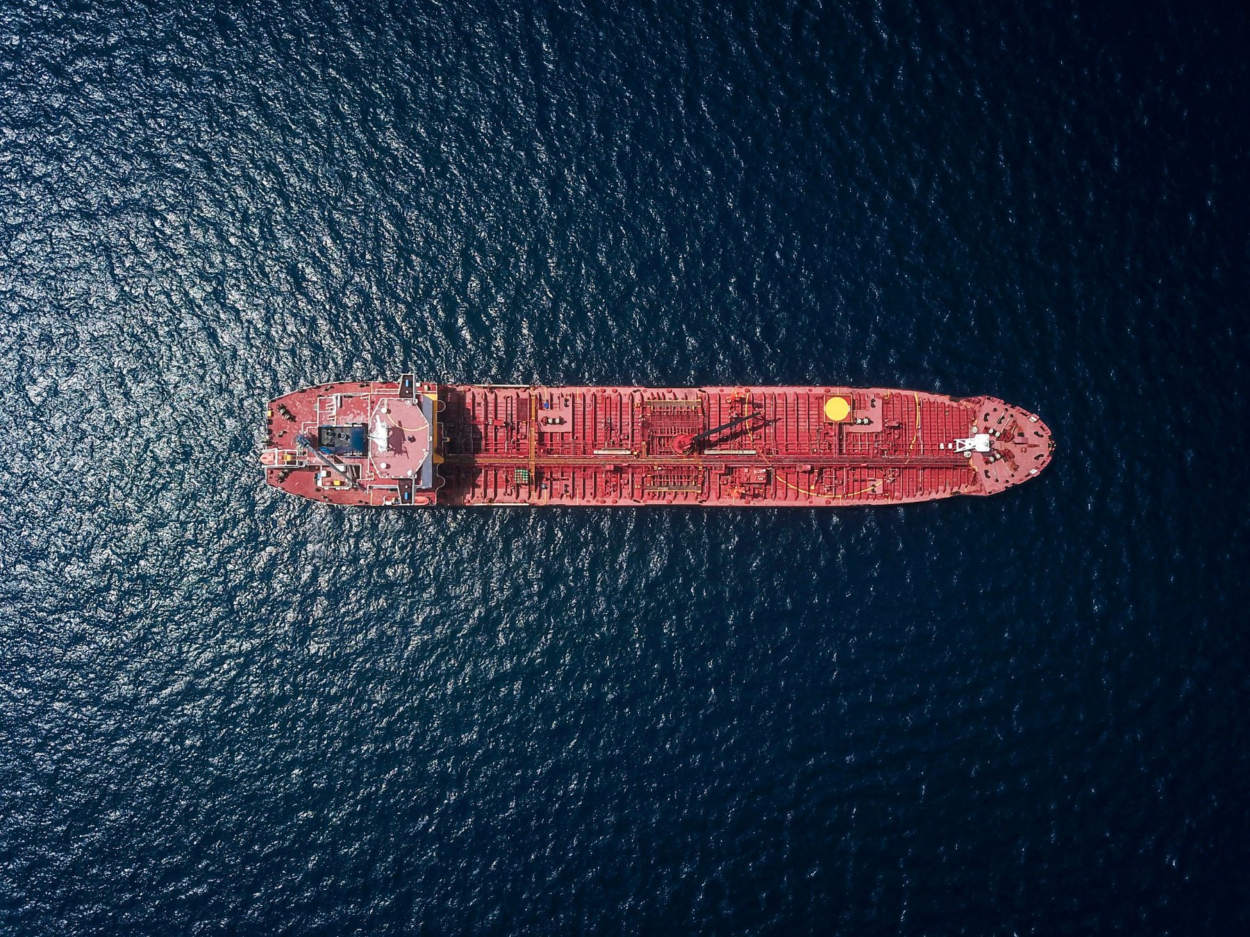 Aerial view of a cargo vessel crossing open ocean