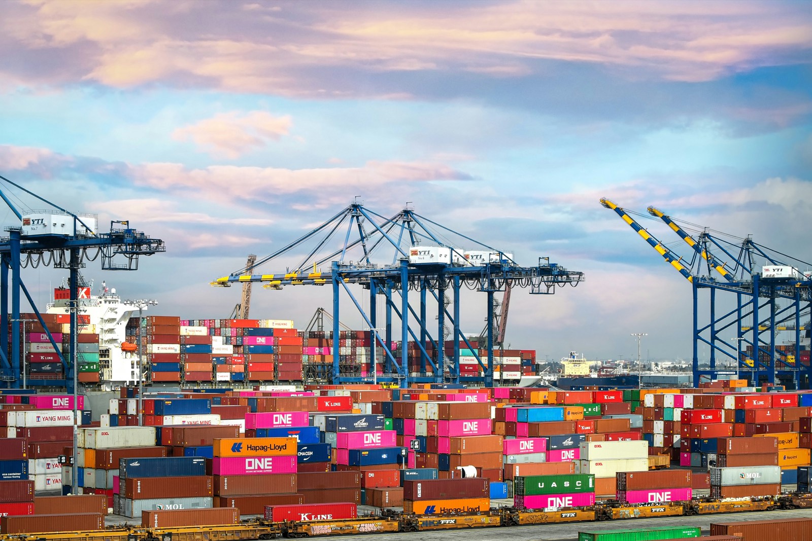 Container port with gantry cranes at dusk