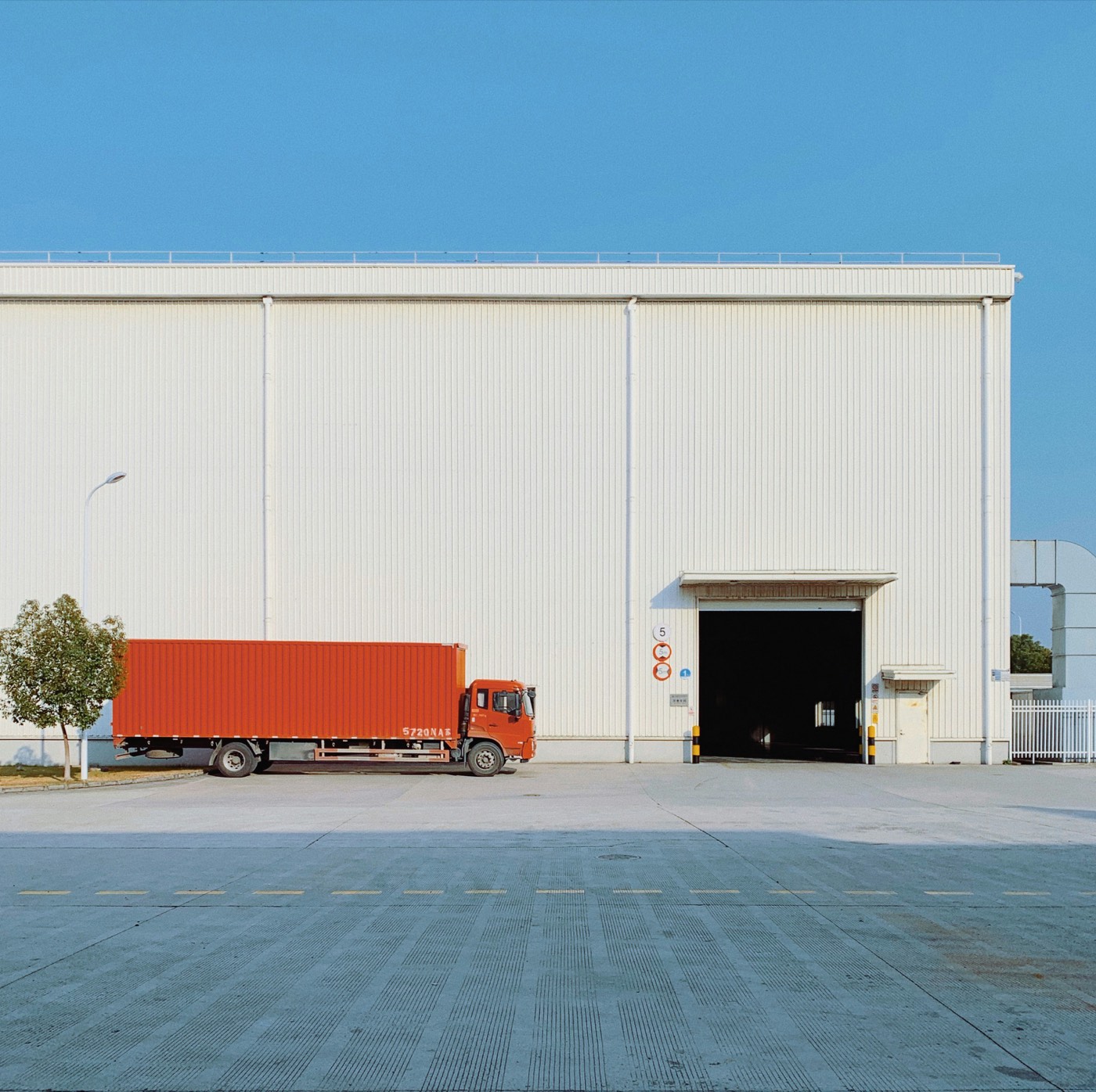 Freight truck parked at a warehouse door